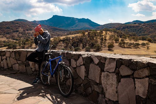 A Man Standing Beside His Bicycle