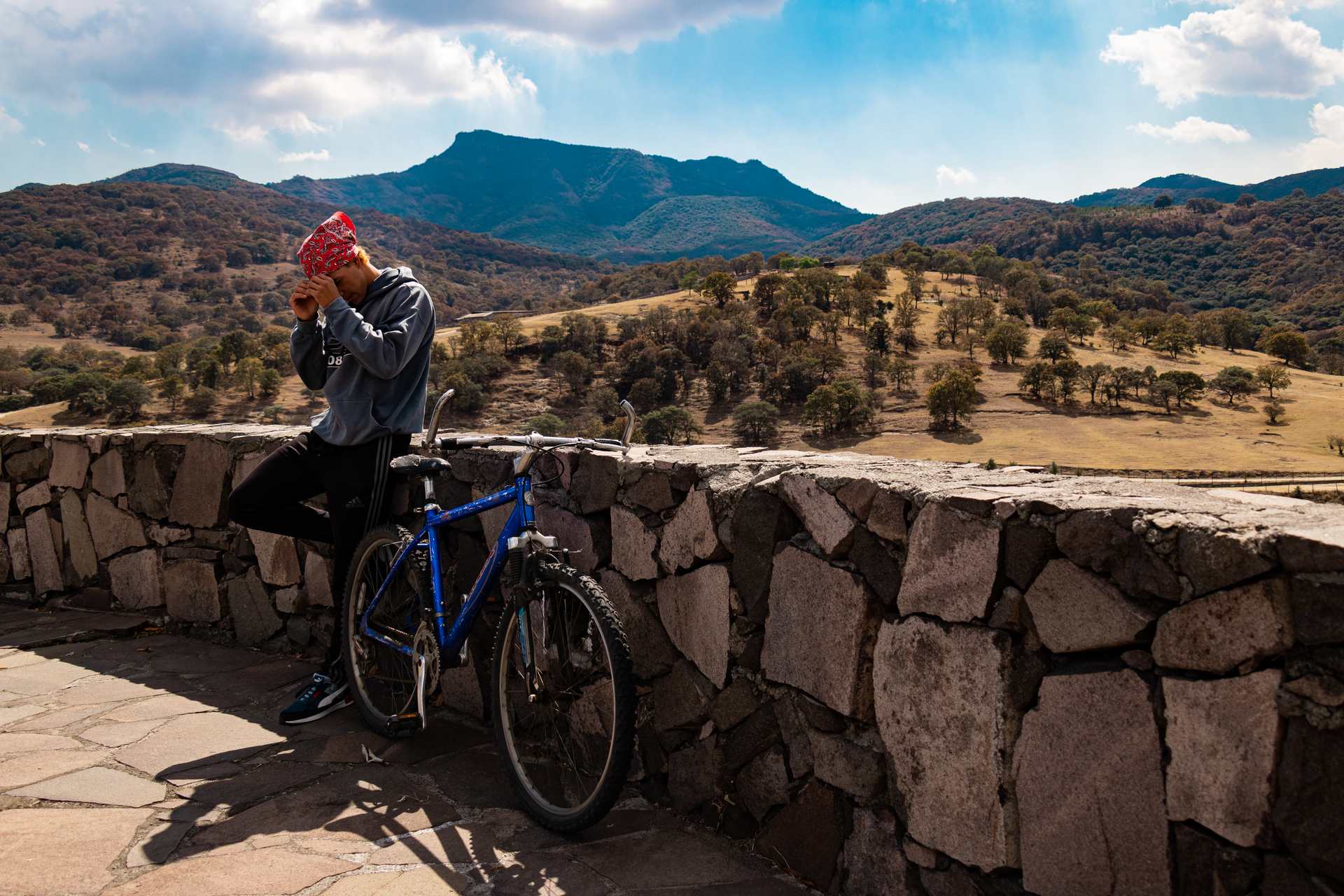 Mountain biker takes a break in the picturesque landscapes of Mexico. Ideal for travel and adventure themes.