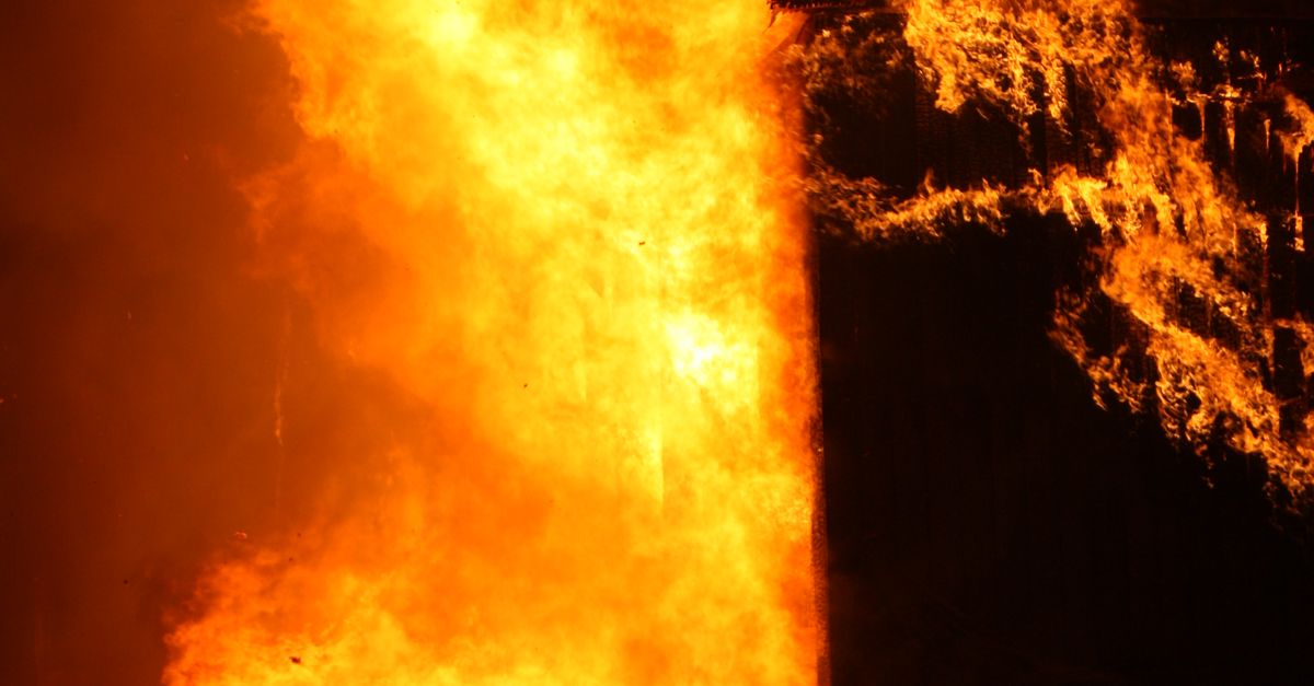 Photo by Vladimir Shipitsin Dramatic image of a building engulfed in flames at night, showcasing danger and intensity.