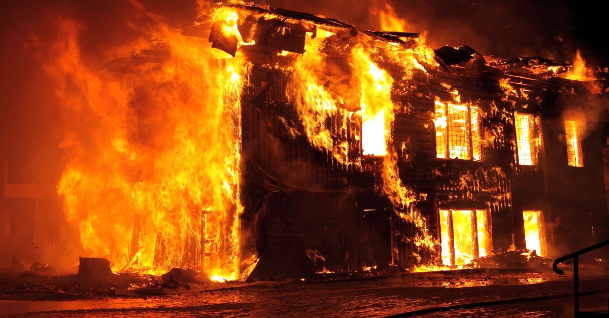 Rüyada İş Yerinde Yangın Çıkması - Rüya Tabiri ve Anlamı - A dramatic nighttime scene of a house engulfed in flames in Tulan, Russia.