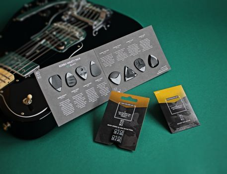Variety of Guitar Picks and an Electric Guitar