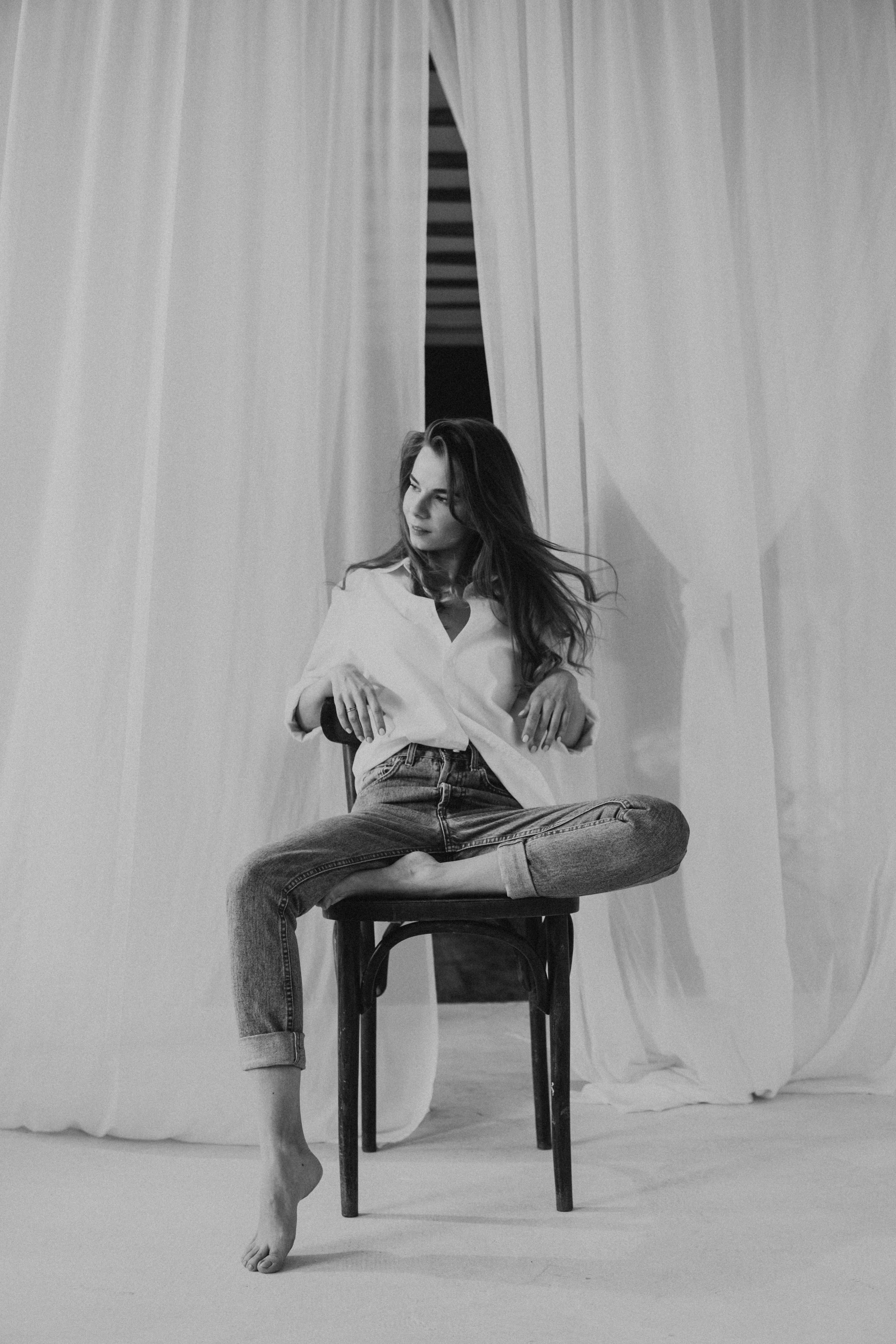 Woman in White Long Sleeve Shirt Sitting on Chair · Free Stock Photo