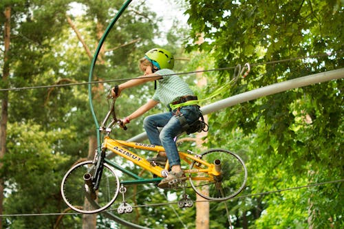 Free Kid Riding a Bike on a Rope Stock Photo
