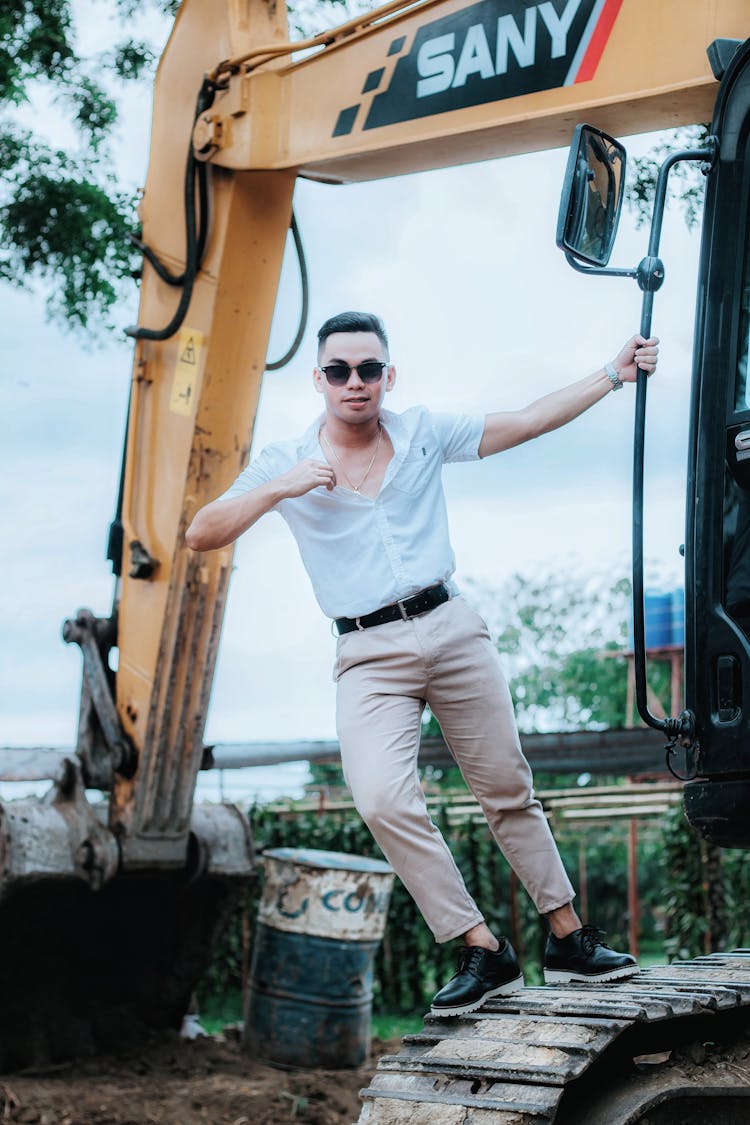 Man Posing On A Backhoe