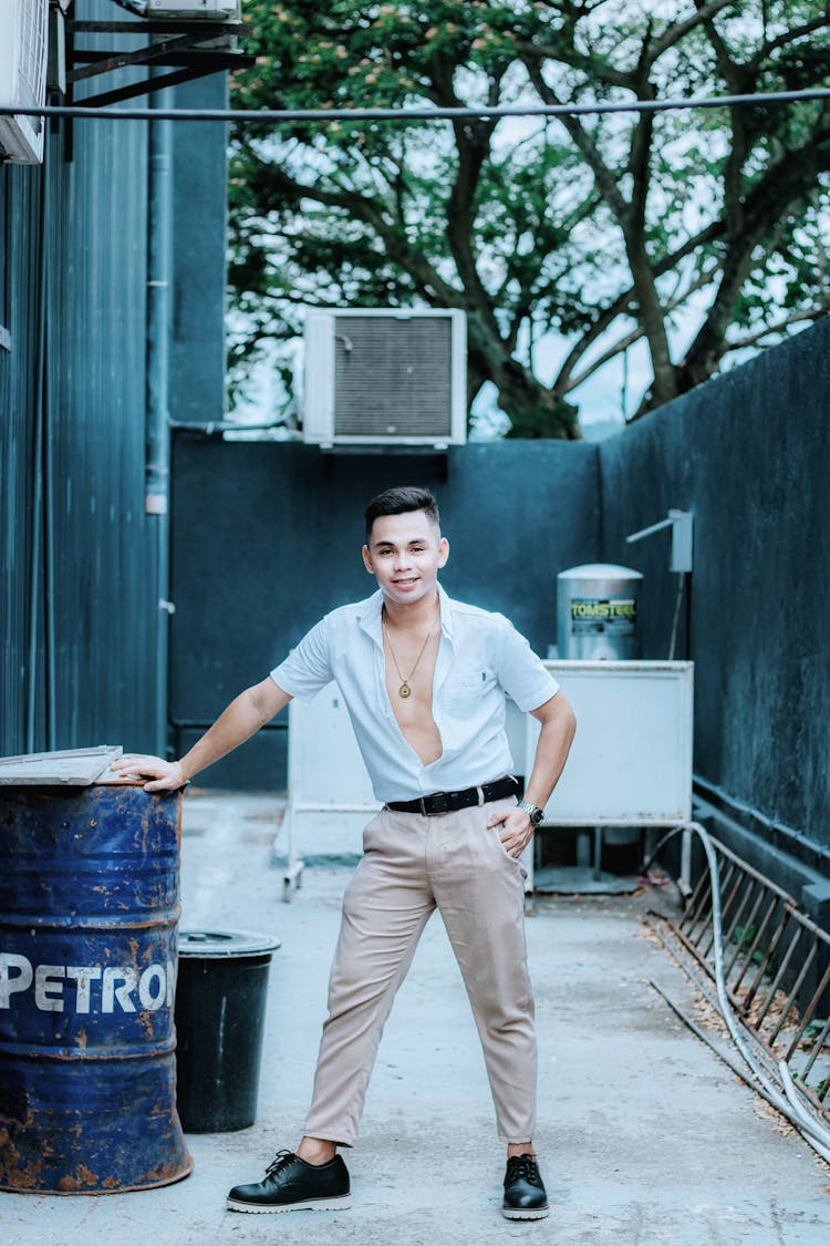 Man In Button Down Shirt Holding A Barrel