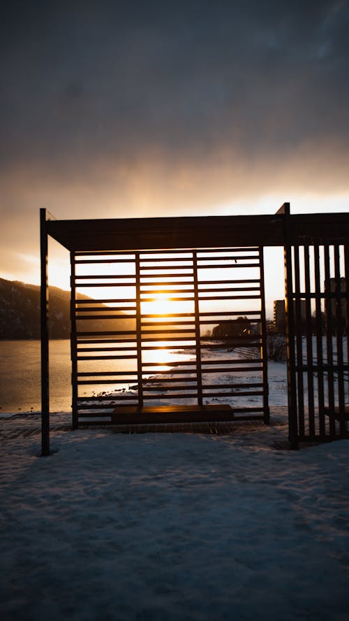 A Wooden Structure on a Snow Covered Surface during the Golden Hour