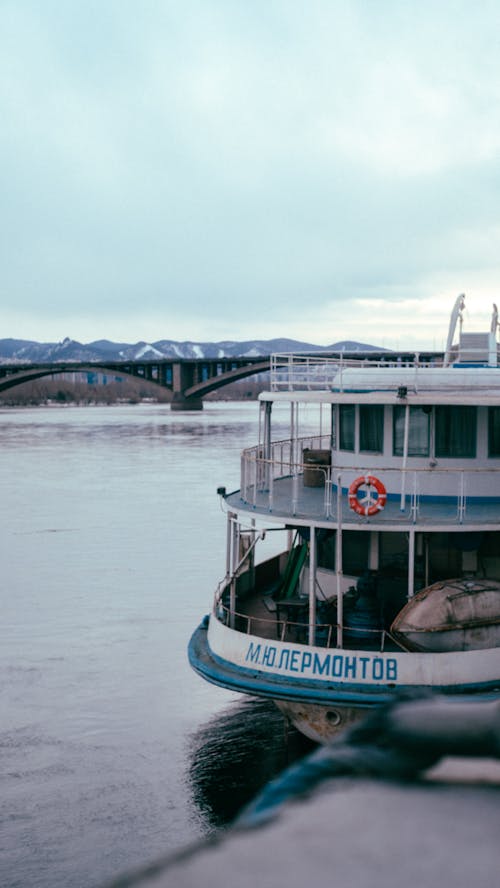 Docked Ferry near a Bridge