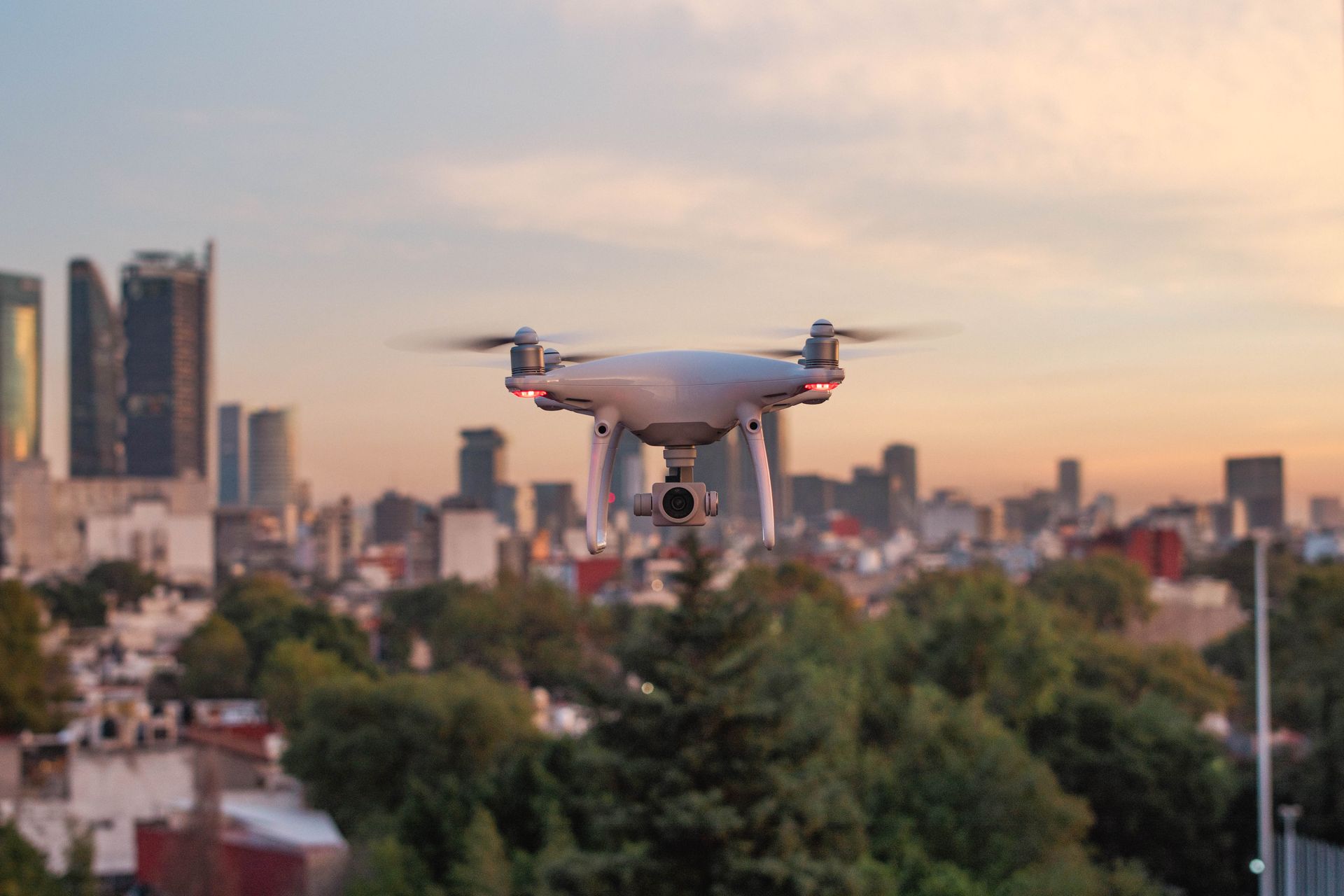 A commercial drone flying against a city skyline