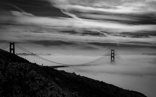 Free Stunning aerial view of the Golden Gate Bridge engulfed in fog, captured in black and white. Stock Photo