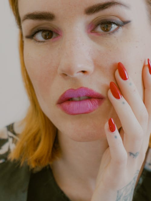 Woman in Green Shirt With Red Lipstick