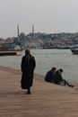 Man and Woman Sitting on Brown Wooden Dock