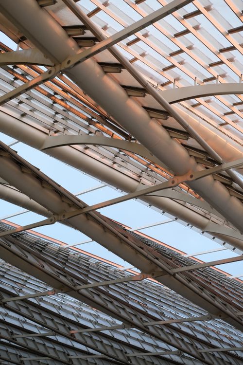 Free Close-up shot of modern architectural steel beams and glass roof with natural light. Stock Photo