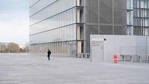A Person Walking in Front of a Building