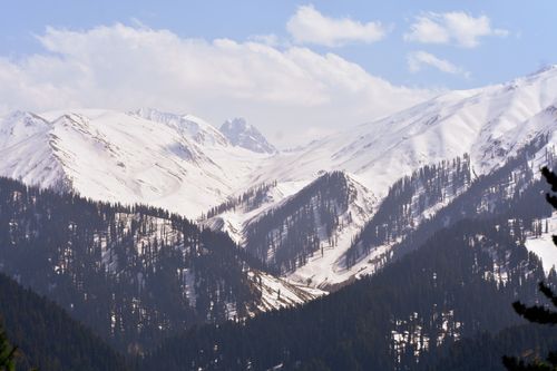 Free Stunning winter landscape of snow-covered mountains under a bright blue sky. Stock Photo