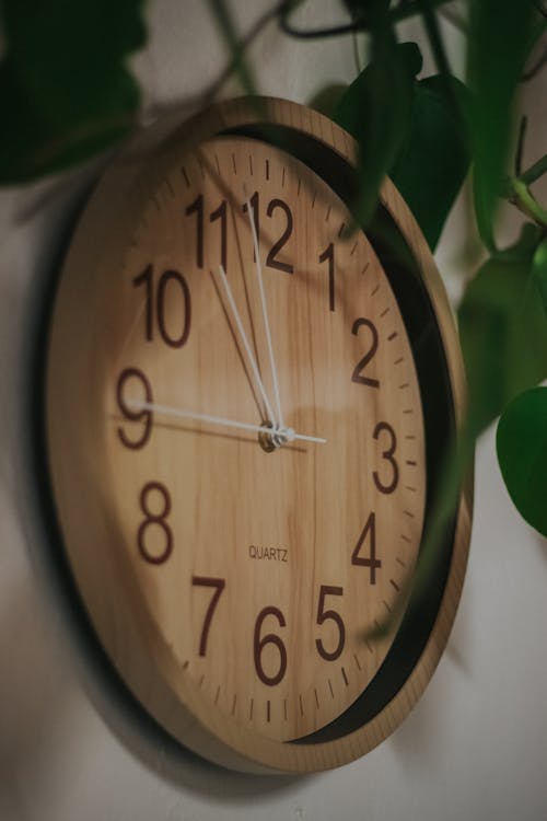 Free A Wooden Clock Hanging on the Wall Stock Photo