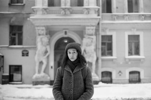 Grayscale Photo of Woman Wearing Winter Clothes