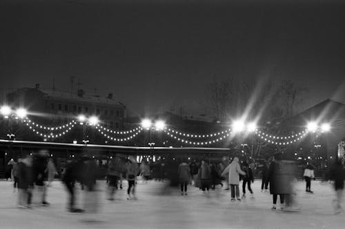 People Ice Skating in the Park at Nighttime