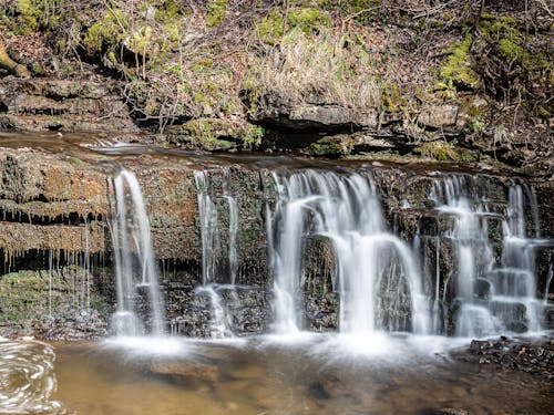 Cascading Waterfalls on Mossy Rocks 