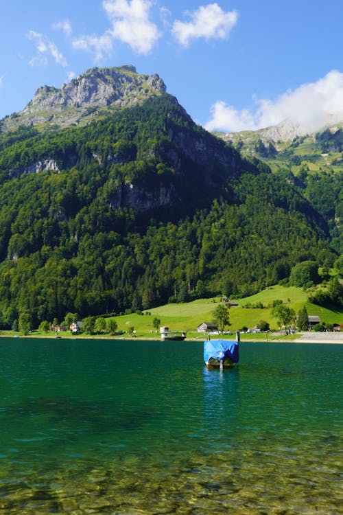 A Sailboat on the Lake Near the Mountain