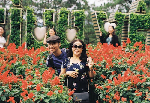 A Man and Woman Standing in the Middle of the Flower Farm
