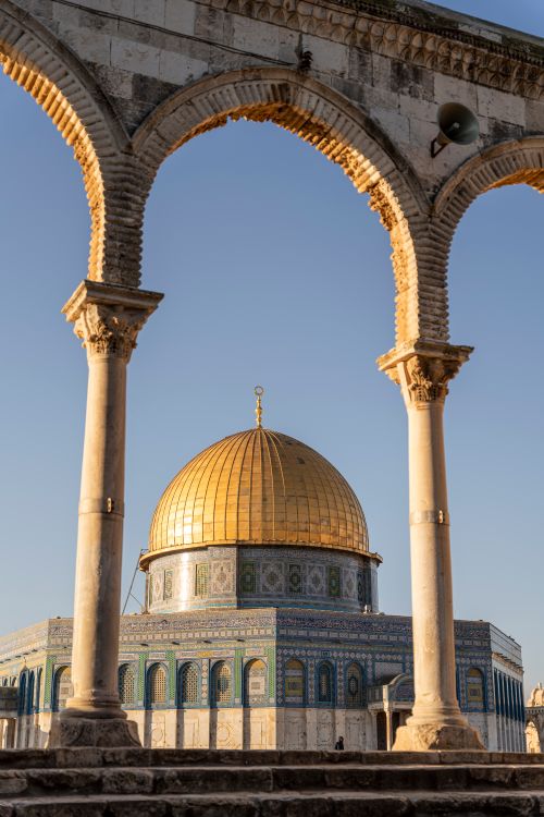 Free Stunning view of the Dome of the Rock captured through ancient arches in Jerusalem. Stock Photo