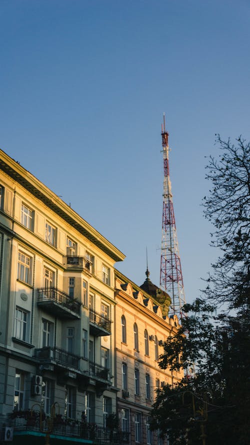 A Low Angle Shot of a Building Near the Cell Tower