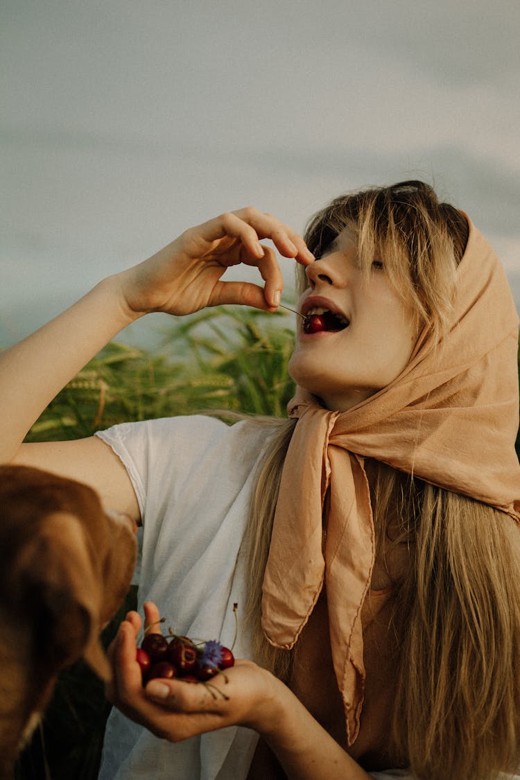 Woman Eating Cherries