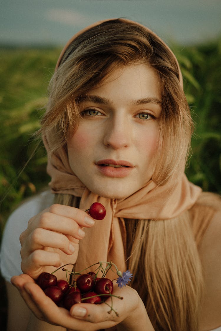 Woman Holding Cherries In Hand 