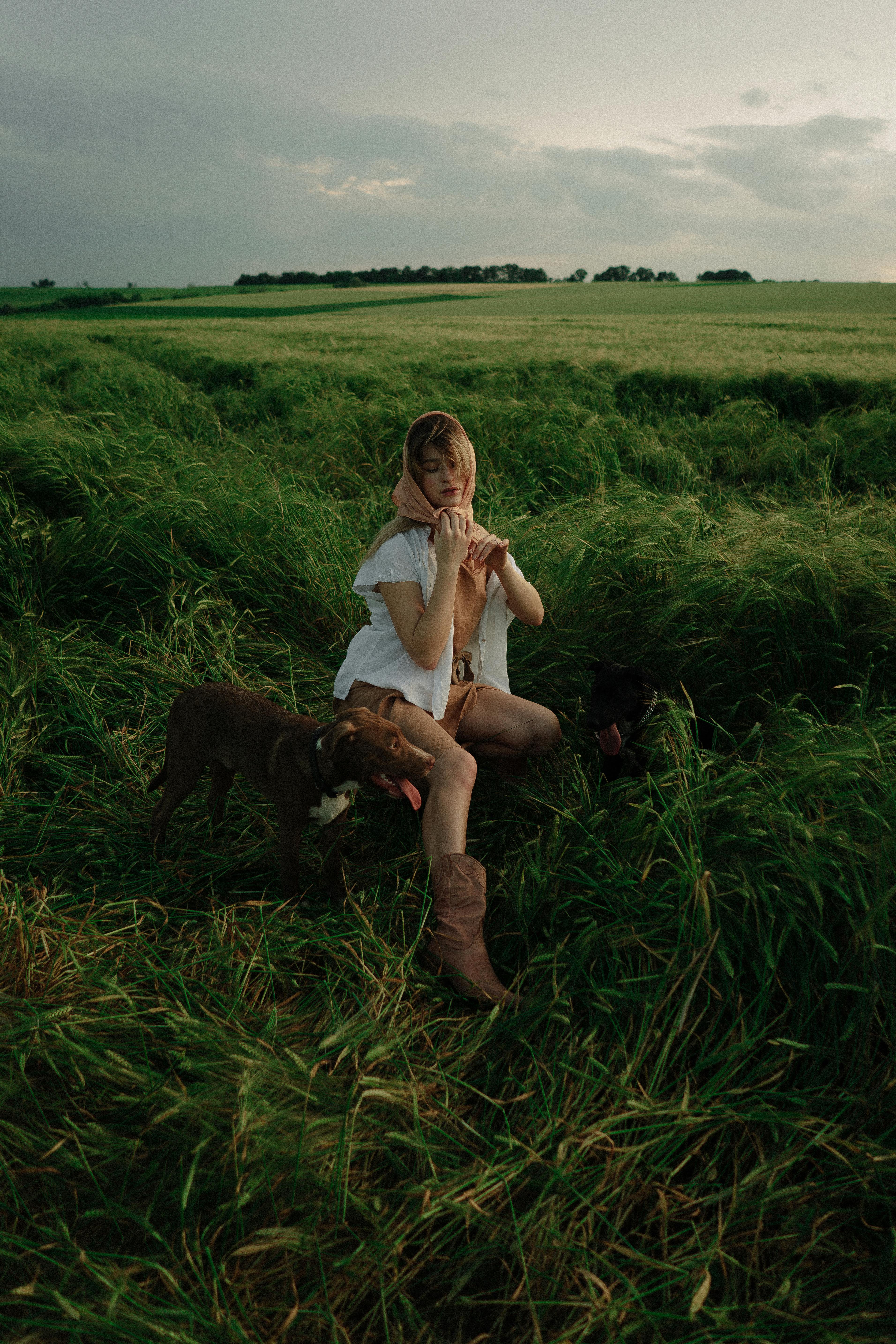 woman posing on a field with a dog