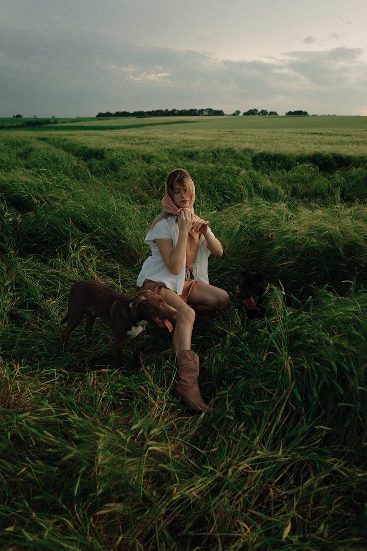 Woman Posing On A Field With A Dog