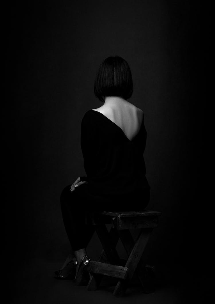 Artistic Photograph Of Sitting Woman In Black Shirt