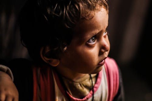 A Close-up Shot of a Child Looking Up