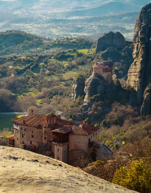 Free Breathtaking view of ancient Meteora monasteries perched atop rock formations in Greece under clear skies. Stock Photo
