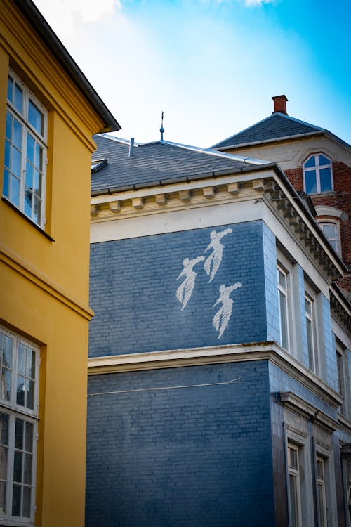 Three Painted Dancers on House Wall