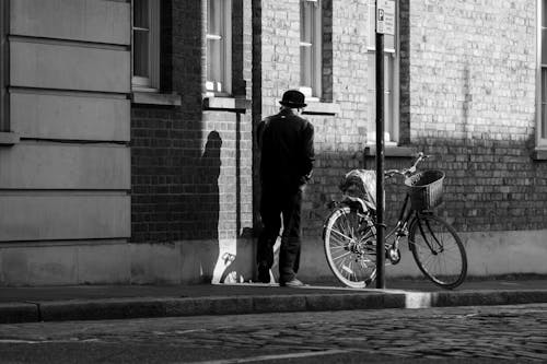 Free A Man Standing on the Sidewalk  Stock Photo