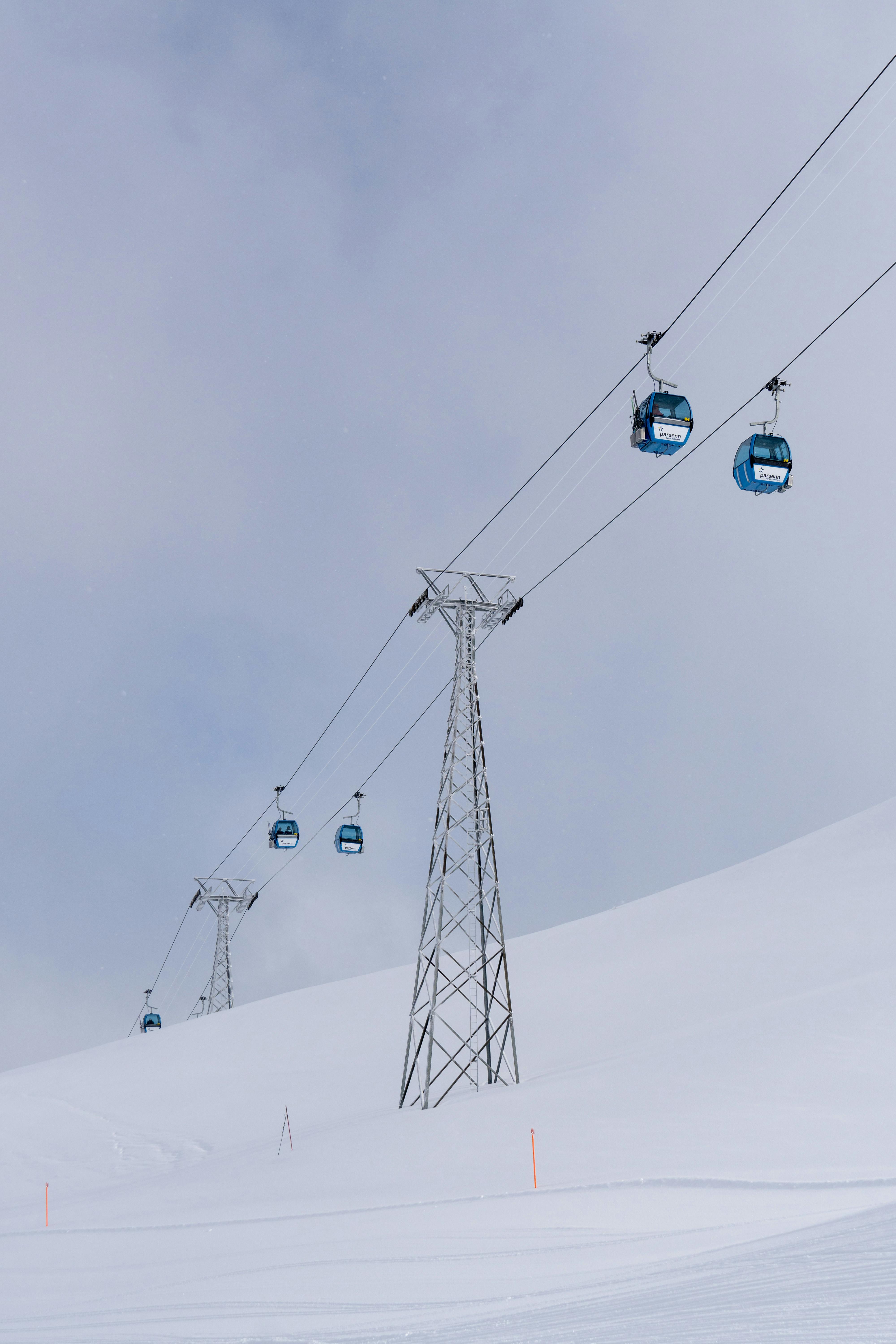 Prescription Goggle Inserts - Cable cars travel over a snowy winter landscape, offering scenic views of the mountains.