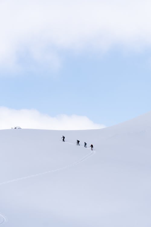 Free A Group of People Hiking on a Snow Covered Mountain Stock Photo
