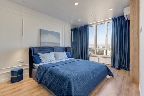Bed with Blue Sheets in Bedroom