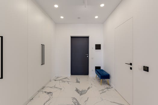 Sleek and contemporary corridor with marble flooring and white walls.