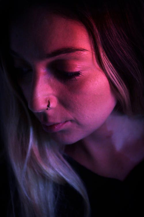 A close-up Shot of a Woman with Nose Piercing