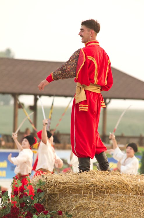 Man Standing on Haystack