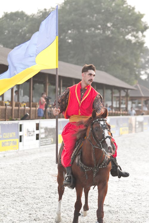 Free Man on Horse Holding Ukrainian Flag Stock Photo