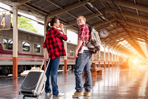 Free Man and Woman in Red Flannel Shirts at the Subway Stock Photo
