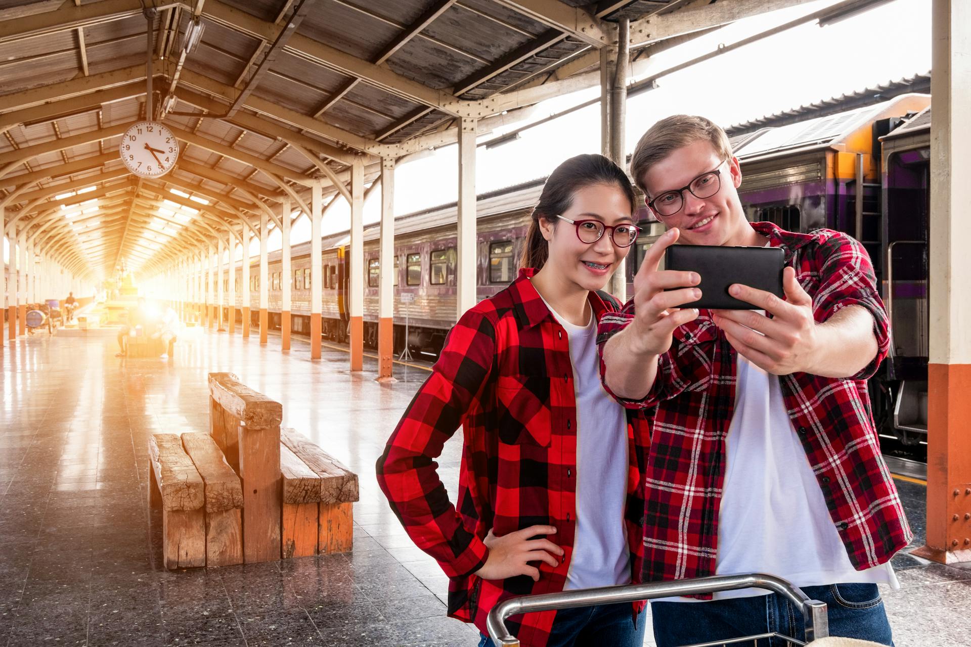 Man and Woman Taking Selfie Near Gray Train