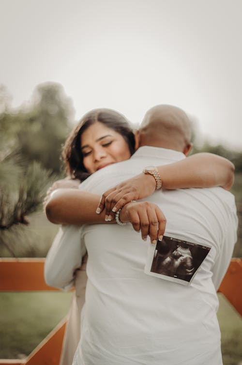 Free An Expecting Couple Hugging Stock Photo