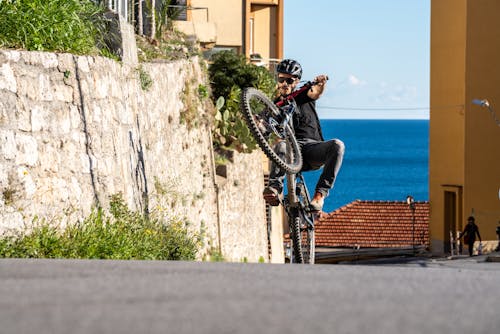 A Man Riding a Mountain Bike Doing Wheelie