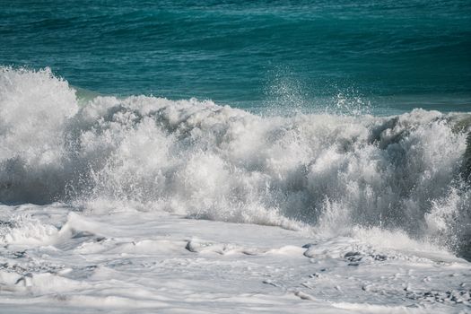 Dynamic waves crash on the shores of Finale Ligure, capturing the essence of the Ligurian coast.