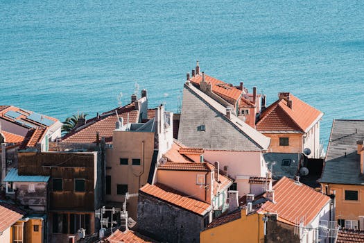 Colorful rooftops of Finale Ligure overlooking the blue sea, Liguria, Italy.