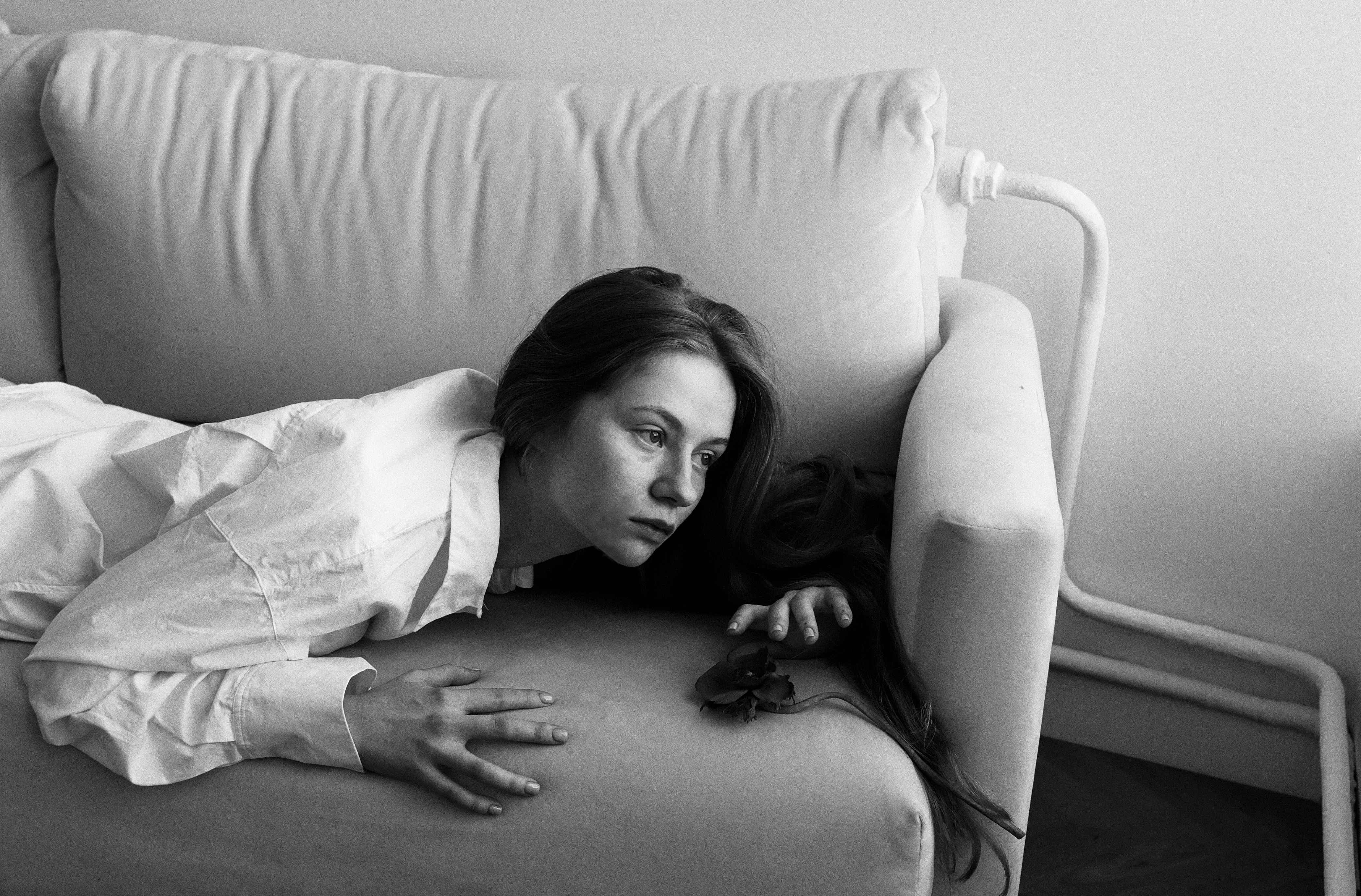 A Woman in White Long Sleeves Lying Down on the Couch · Free Stock Photo