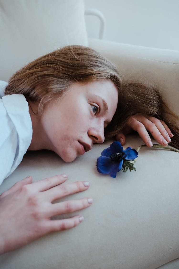 Sad Redhead Girl Lying On Sofa 